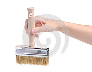 Hand holding building paint brush