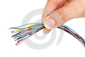 Hand holding bunch of different colored wires