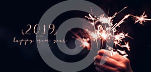 Hand holding burning Sparkler blast with happy new year 2019 on