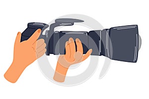 Hand holding camera. Photographer taking pictures. Professional photo or video shooting.
