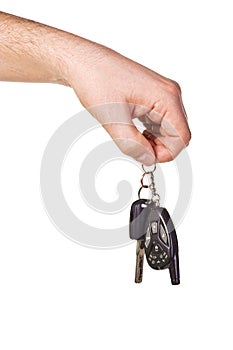 Hand holding car key and remote control