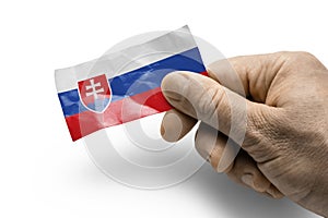 Hand holding a card with a national flag the Slovakia