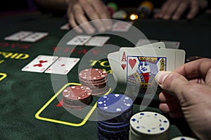 hand holding cards at poker table with chips stacked