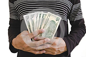 Hand holding cash, selective focus on hand isolated on white background