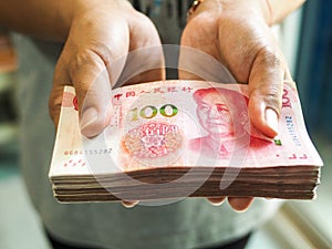 Hand holding cash yuan
