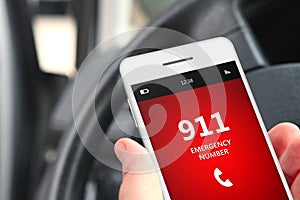 Hand holding cellphone with emergency number 911