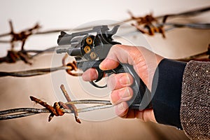 Hand Holding a Charged Revolver