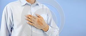 Hand holding the chest concepts of burning chest pain or sensation in middle of chest and health care for the treatment of illness