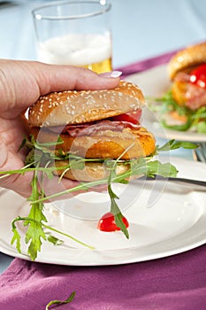 Hand holding a chickenburger