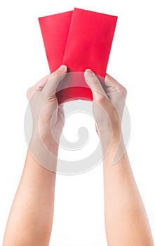 Hand holding chinese red envelope with money isolated over white background.