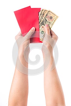 Hand holding chinese red envelope with money isolated over white background.