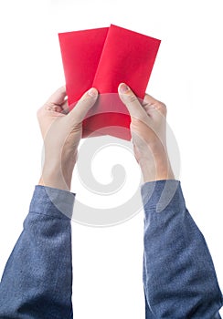 Hand holding chinese red envelope with money isolated over white background.