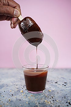 Hand holding Chocolate covered homemade cakesicle