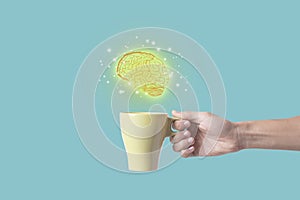 Hand holding coffee cup with brain. concept for new ideas