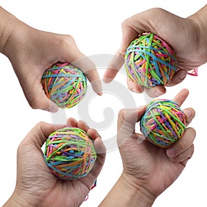 Hand holding colorful multi color elastic rubber bands ball isolated on white