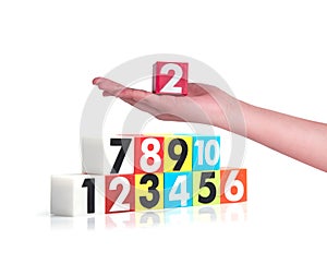 Hand holding colorful plastic numbers on white background ,No1