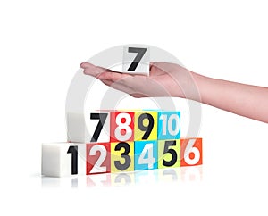 Hand holding colorful plastic numbers on white background ,No1