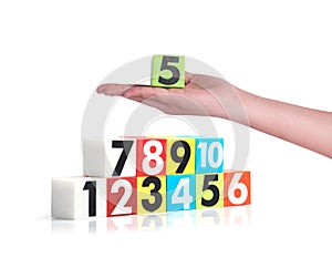 Hand holding colorful plastic numbers on white background , No1