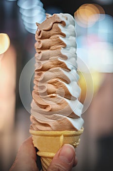 Hand Holding Cone of Ice Cream