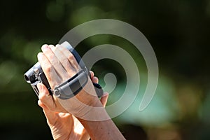 Hand-holding and control the video camera with a natural background.