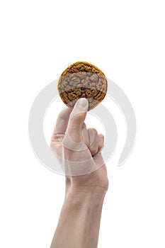 Hand holding cookie in mid air isolated on white