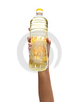 hand holding cooking oil in plastic bottle