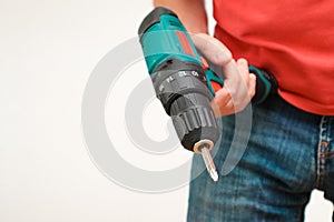 Hand holding cordless drill. Handyman with a tool screwdriwer drill