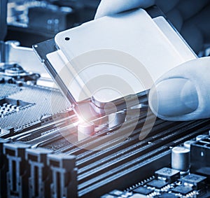 Hand holding a CPU and inserts it into the motherboard