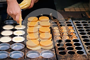 hand holding cream cooking sweet pancake Dorayaki , delicious japanese street food in japan