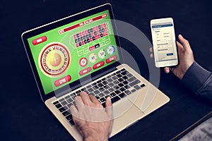 Hand holding credit card playing online gambling