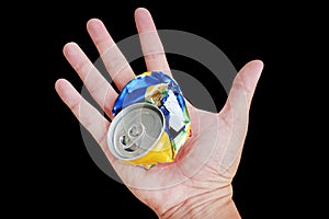Hand holding a crumpled garbage can isolated over black background