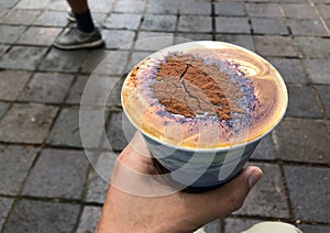 Hand holding a cup of coffee