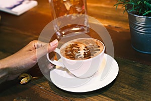 Hand holding a cup of hot cocoa