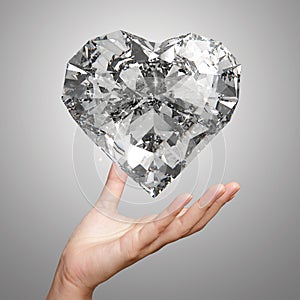 Hand holding 3d diamond heart shape