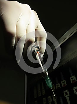 Hand holding dentist syringe to give injection