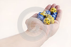 Hand holding dice for dnd, role playing games and board games