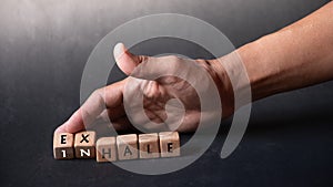 Hand holding dice with text for illustration of `Exhale or Inhale` words