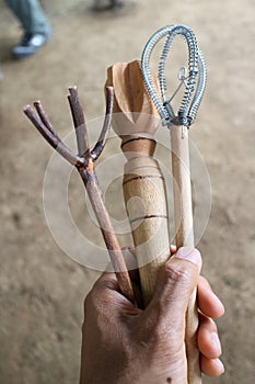 Hand holding different wicks to mix the cocoa to make chocolate drink