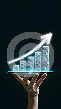 Hand holding digital bar graph showing upward trend with glowing blue arrow on dark background