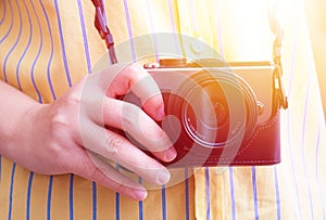 Hand holding digital camera .