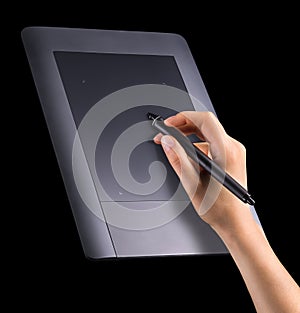 Hand holding digital graphic pen and drawing graphic tablet isolated on black