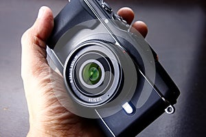 Hand holding a digital mirrorless camera