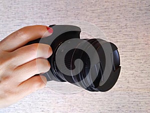 Hand holding a digital slr camera