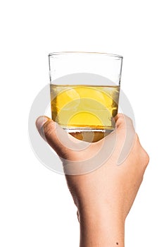 Hand holding a diluted glass of whiskey on the rocks