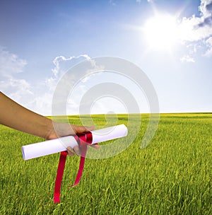 Hand holding Diploma wrapped