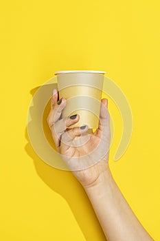 Hand holding disposable paper cup