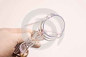 Hand holding disposable speculum photo