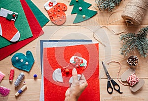 A hand holding DIY Christmas felt stocking, Christmas and New Year children& x27;s crafts