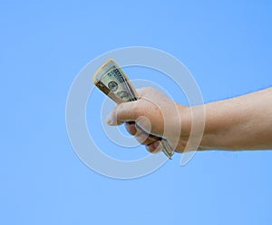 Hand holding dollar notes