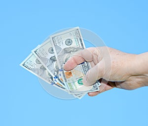 Hand holding dollar notes